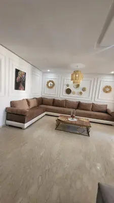a living room with a couch and a coffee table at Cité Marine in Mansouria
