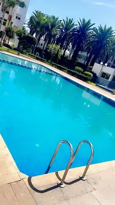 a swimming pool with a metal object in front of it at The hidden oasis, steps from the beach and pool in Mohammedia