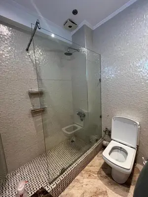a bathroom with a toilet and a glass shower at Elégance et confort au coeur de Casablanca in Casablanca