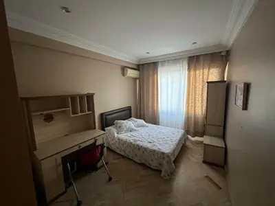 a bedroom with a bed and a desk and a window at Elégance et confort au coeur de Casablanca in Casablanca