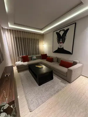a living room with a couch and a coffee table at Beau studio au cœur du parc in Mohammedia