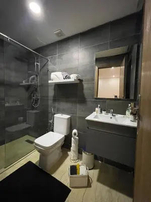 a bathroom with a toilet and a sink and a shower at Beau studio au cœur du parc in Mohammedia