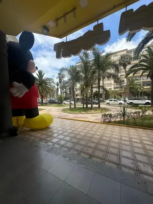 a mickey figurine sitting on the side of a building at Beau studio au cœur du parc in Mohammedia