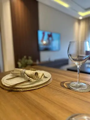 a napkin and a glass of wine on a table at Beau studio au cœur du parc in Mohammedia