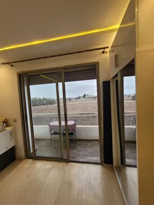 a living room with sliding glass doors and a table at Charmante villa vue sur la mer in Tamaris