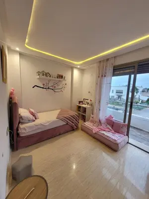 a bedroom with two beds and a window at Charmante villa vue sur la mer in Tamaris