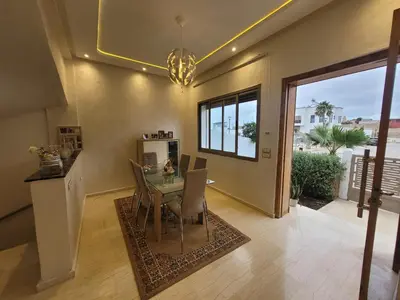 a dining room with a glass table and chairs at Charmante villa vue sur la mer in Tamaris