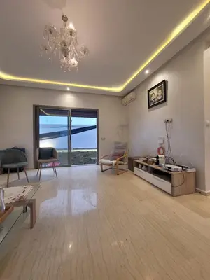 a large living room with a chandelier and a couch at Charmante villa vue sur la mer in Tamaris