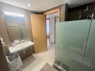 a bathroom with a glass shower and a sink at Zen & Welcoming CFC - Garage & Tramway in Casablanca