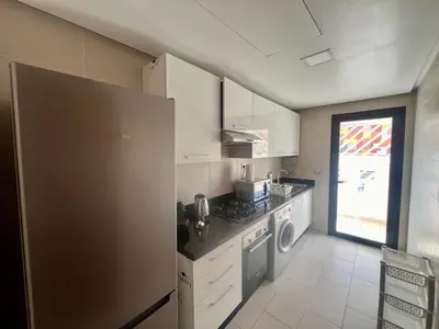 a kitchen with a refrigerator and a stove top oven at Zen & Welcoming CFC - Garage & Tramway in Casablanca