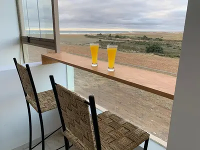two glasses of orange juice sitting on a table at Appartement de luxe avec vue sur mer in Bouznika
