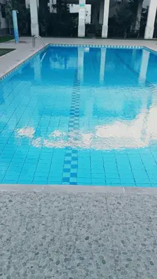 a blue swimming pool with blue tiles on the ground at Residence Luxueuse avec 2 Piscines à Harhoura Temara proximité plages princesses & Sables d'Or in El Harhoura