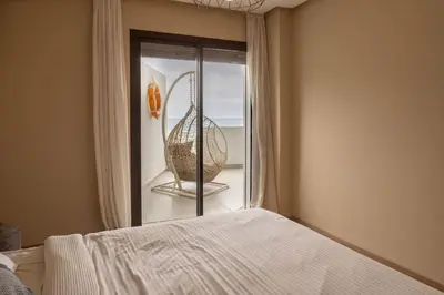 a bedroom with a bed and a window with a basket at Magnifique appartement front mer in Tamaris