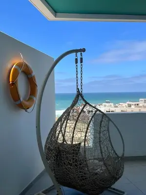 a swing with a ball in a room with a window at Magnifique appartement front mer in Tamaris