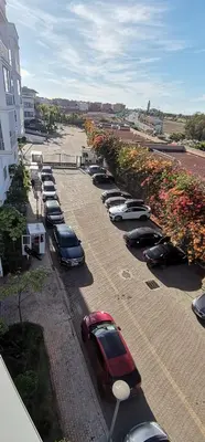 a row of cars parked in a parking lot at Grand appartement vue golf a 2 min de la plage Bouznika in Bouznika