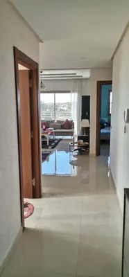 a living room with a view of a living room at Grand appartement vue golf a 2 min de la plage Bouznika in Bouznika