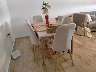 a dining room table and chairs in a living room at heaven beach sidi rehal in Sidi Rahal