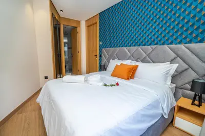 a bedroom with a large white bed with an orange pillow at Twenty Four Inn 306 in Casablanca