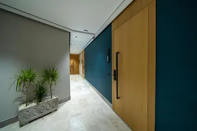 a hallway with blue walls and a door and plants at Twenty Four Inn 306 in Casablanca