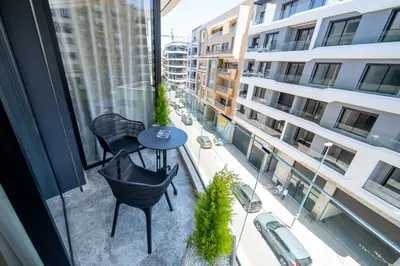 a balcony with a table and chairs and a building at Twenty Four Inn 306 in Casablanca