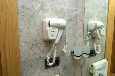 a hair dryer and a phone in a bathroom at Twenty Four Inn 306 in Casablanca