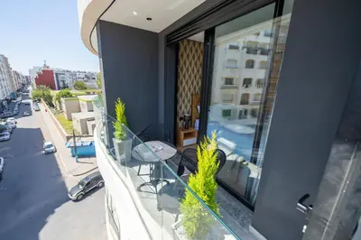 a balcony with a table and chairs on a building at Twenty Four Inn 302 in Casablanca