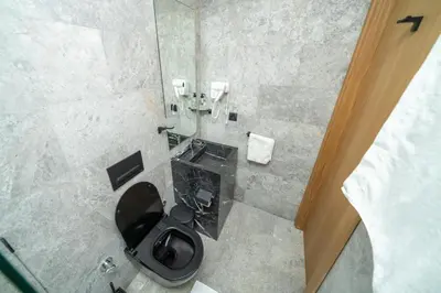 a bathroom with a black toilet and a sink at Twenty Four Inn 302 in Casablanca