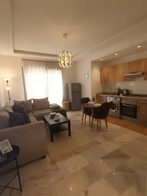 a living room with a couch and a table at Superhote in Nouaceur