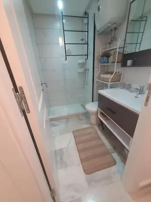 a bathroom with a shower and a toilet and a sink at Superhote in Nouaceur