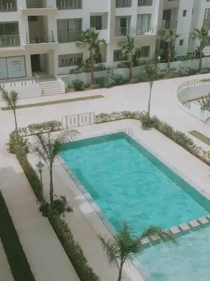 an overhead view of a swimming pool in a building at Superhote in Nouaceur