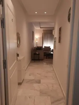 a hallway leading to a room with a living room at Superhote in Nouaceur