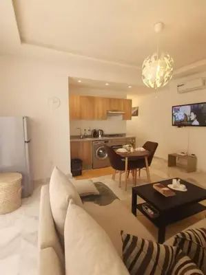 a living room with a couch and a table at Superhote in Nouaceur