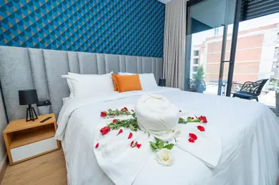a bedroom with a white bed with flowers on it at Twenty Four Inn 303 in Casablanca