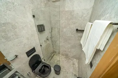 a bathroom with a toilet and a glass shower at Twenty Four Inn 303 in Casablanca
