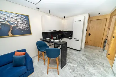 a living room with a blue couch and a table at Twenty Four Inn 303 in Casablanca