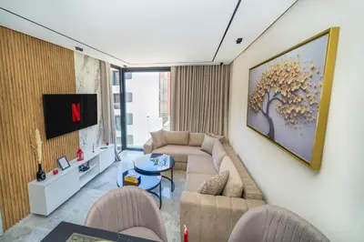 a living room with a couch and a tv at Twenty Four Inn 305 in Casablanca