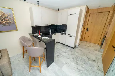 a kitchen with white cabinets and a table and chairs at Twenty Four Inn 305 in Casablanca