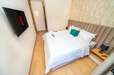 a bedroom with a large white bed with green pillows at Twenty Four Inn 305 in Casablanca