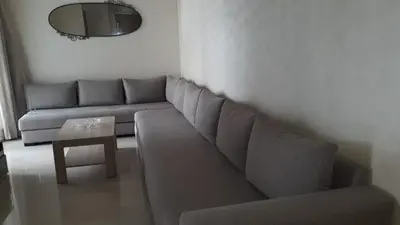 a living room with a couch and a table at Appartement Sidi Rahal in Berrechid