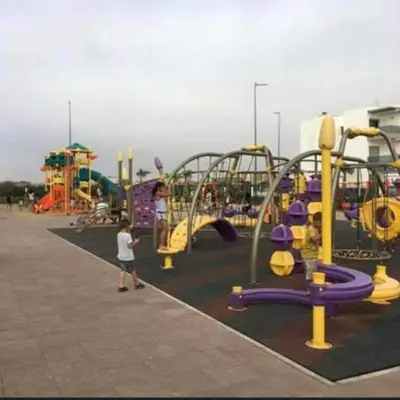 a child standing in front of a playground at Appartement Sidi Rahal in Berrechid