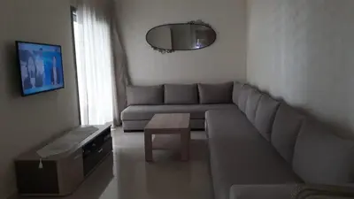 a living room with a couch and a table at Appartement Sidi Rahal in Berrechid