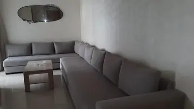 a living room with a couch and a table at Appartement Sidi Rahal in Berrechid