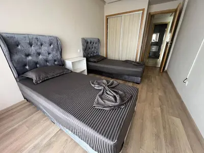a bed in a room with a couch and a chair at Cozy New Apartment in Tamaris in Dar Bouazza