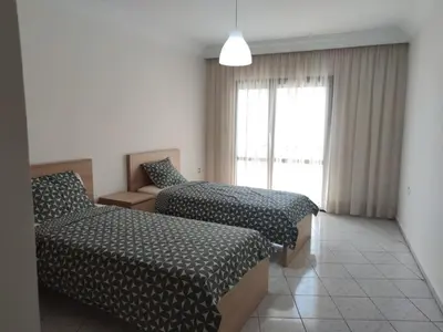 a hotel room with two beds and a window at Appartement de standing in Casablanca