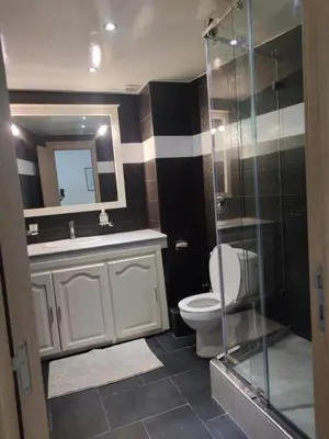 a bathroom with a toilet and a glass shower at Appartement de standing in Casablanca