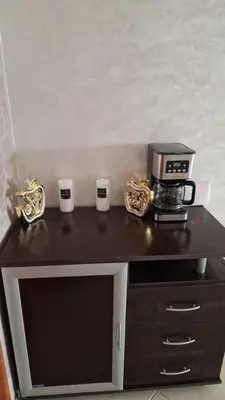 a counter with a coffee maker and three cups on it at Bel Appartement à mimosa mohammedia in Mohammedia
