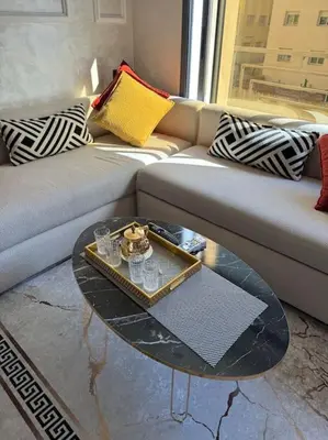 a living room with a couch and a coffee table at Studio meublé neuf Maarif au centre de Casablanca 3 minutes de stade Mohamed V in Casablanca