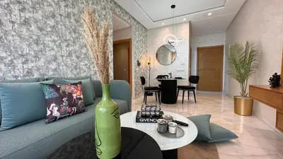 a living room with a blue couch and a table at Chic Family Place - by AppartAli in Casablanca