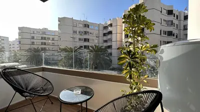 a balcony with two chairs and a table and a window at Chic Family Place - by AppartAli in Casablanca