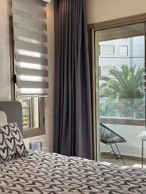 a bedroom with a bed and a large window at Chic Family Place - by AppartAli in Casablanca